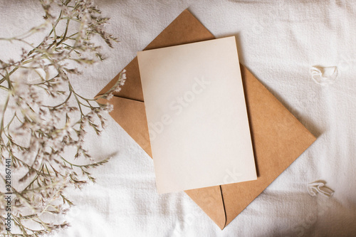 mockup card with plants. invitation card with envelope and details Mockup with postcard and flowers on white background.