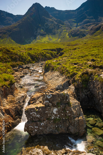 The Fairy Pools, which are cold swimmable pools, multiple waterfalls, that vibrant blue and green in color, that empties into the River Brittle in Glenbrittle, Scotland, UK. 