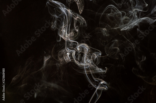 abstract beautiful fragment movement of burn white smoke on black background.