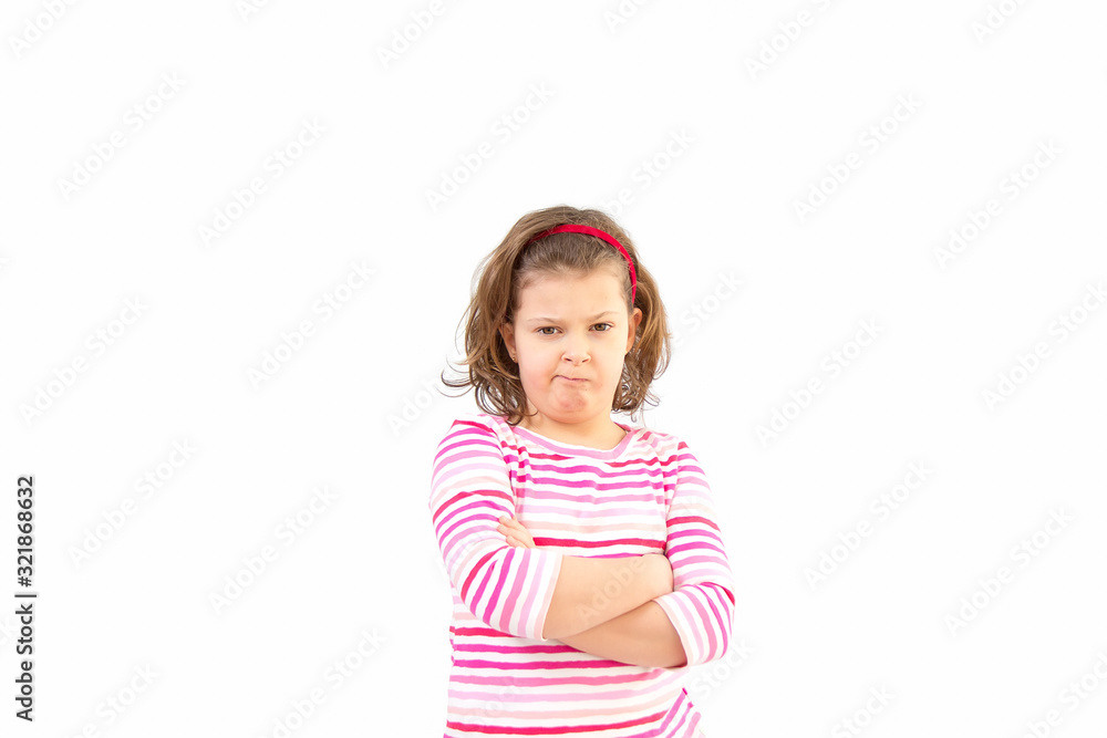 Blond baby showing disapproval with pursed lips.litl girl with blond pony-tail looking seriously, folding hands and frowning eyebrows. Her gloomy appearance says she is very unhappy and offended. Blond baby showing disapproval with pursed lips.litl girl with blond pony-tail looking seriously, folding hands and frowning eyebrows. Her gloomy appearance says she is very unhappy and offended.