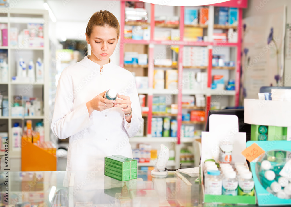 Woman pharmacist working in pharmaceutical shop
