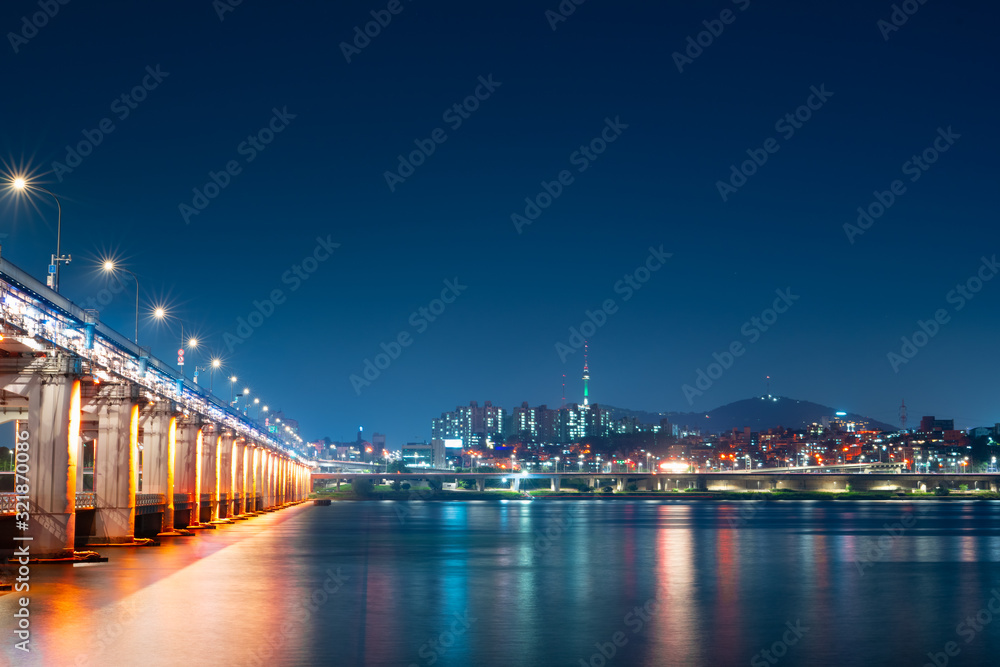 night and city scape travel and photography activity from banpo bridge is beautiful  architecture and design during show fountain moving to people and traveler with reflection in river background