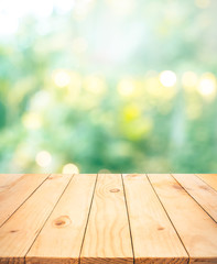 Real wood table top texture on blur leaf tree garden background