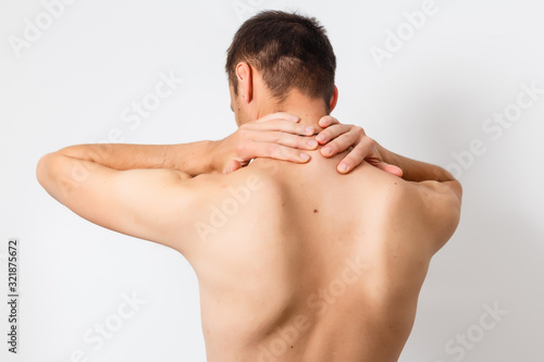 Trendy model on white background having a painful neck