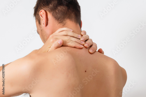 A man holding his injured neck  isolated on a white background