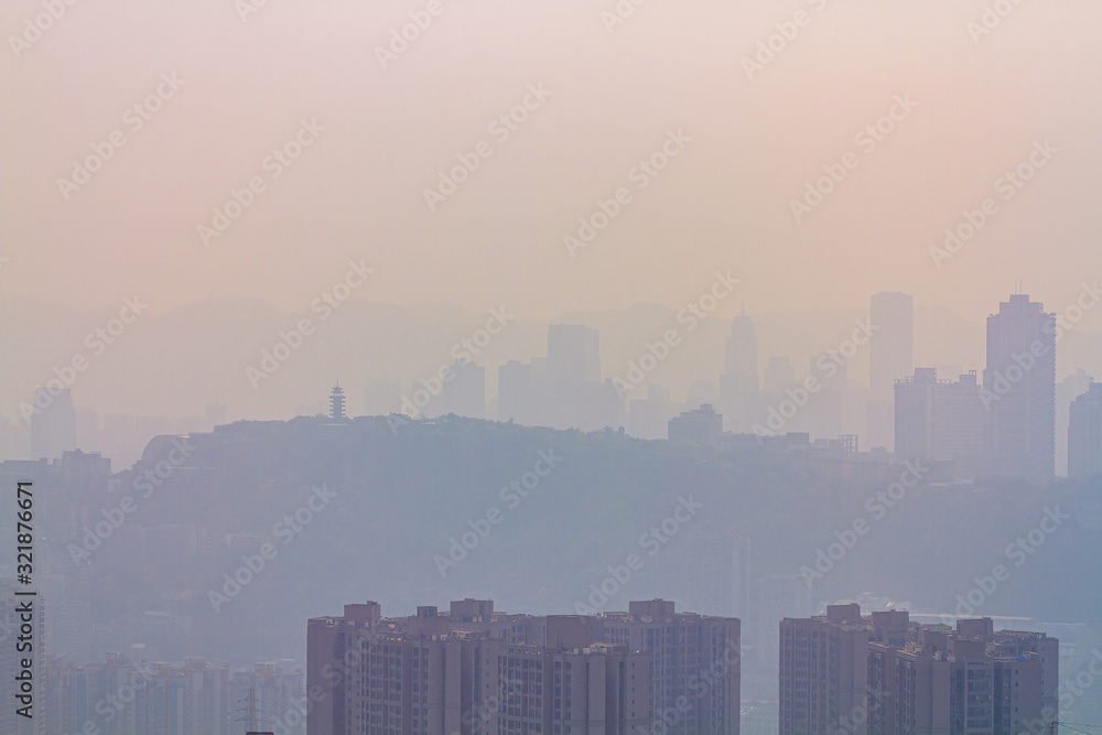 Blurred cityscape in sunrise haze. Chinese city of Chongqing. For a beautiful background, postcard, banner.