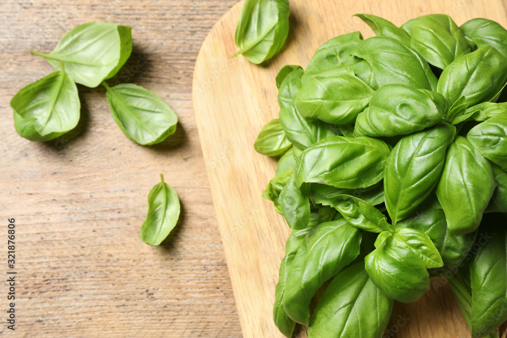 Fresh basil on wooden table, flat lay Fresh basil on wooden table, flat lay