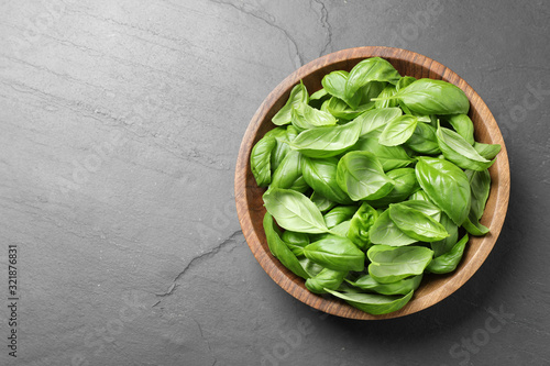 Fresh basil on grey table, top view. Space for text