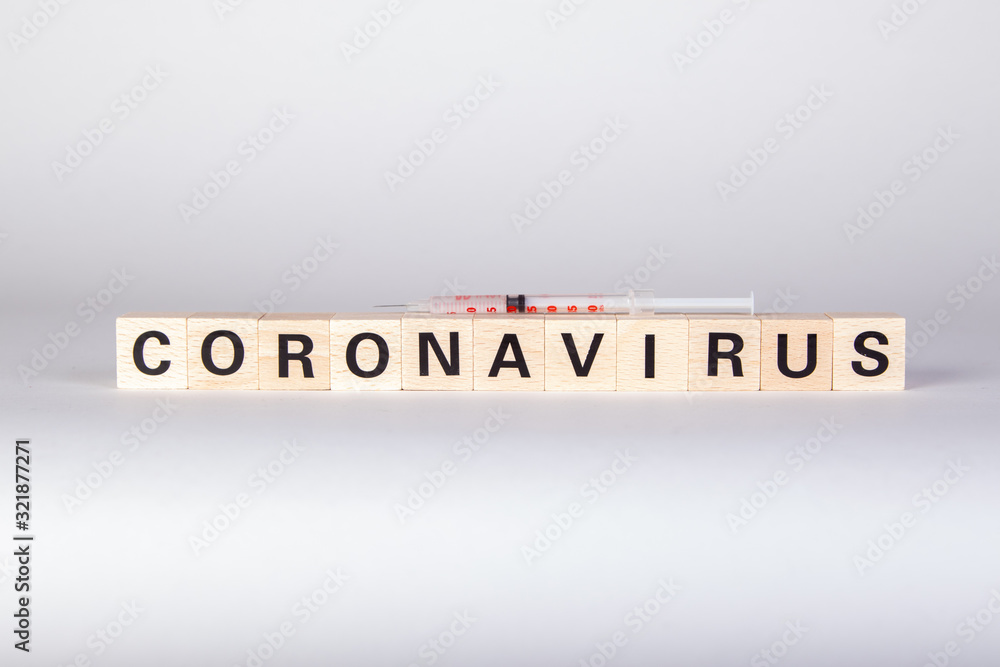 wooden cubes with text coronavirus and a syringe, vaccine, white background wooden cubes with text coronavirus and a syringe, vaccine, white background