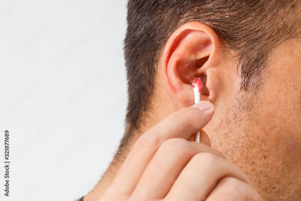 blood on the cotton bud after digging in the ear. this image is closeup and blur background blood on the cotton bud after digging in the ear. this image is closeup and blur background