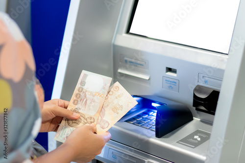 Принти на полотні Woman counting thai baht withdrawn from ATM