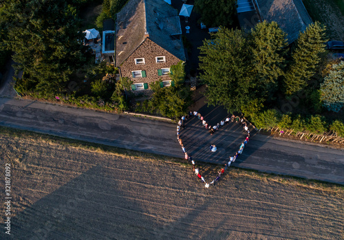 Wedding guests lined up in the shape of heart with bride and groom marriage people photo