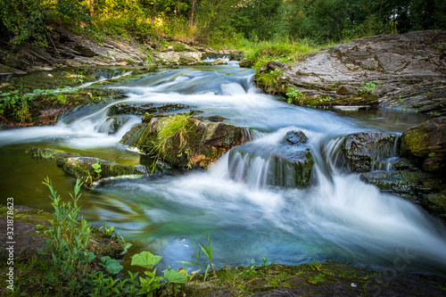 Fototapeta Naklejka Na Ścianę i Meble -  Mountain stream rapids  in motion blur