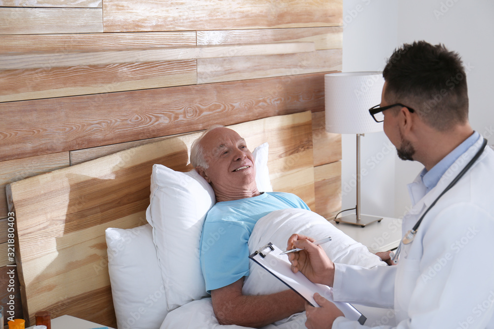 Doctor examining senior patient in modern hospital Doctor examining senior patient in modern hospital
