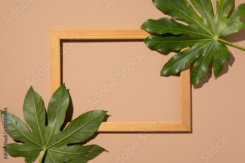 Hipster summer flat lay with border on beige background. Green tropical Palm ...