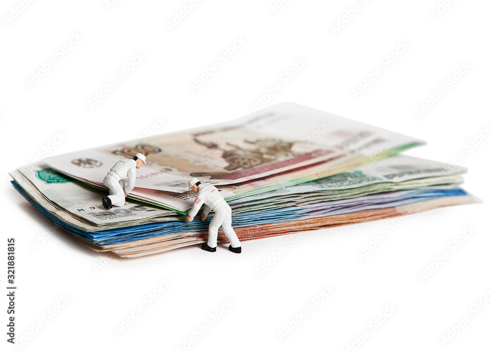 Doll people with Russian paper bills. Isolated on a white background. Doll people with Russian paper bills. Isolated on a white background.