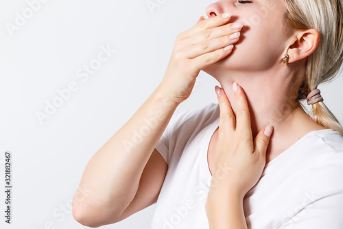 Throat Pain. Ill Woman With Sore Throat Feeling Bad  Suffering From Painful Swallowing  Strong Pain In Throat  Touching Neck With Hand. Beautiful Female Caught Cold. Health Concept. High Resolution