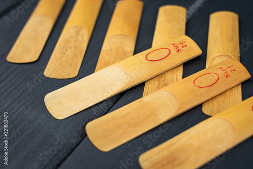 Reeds for a mouthpiece of a wooden instrument on gray wooden background