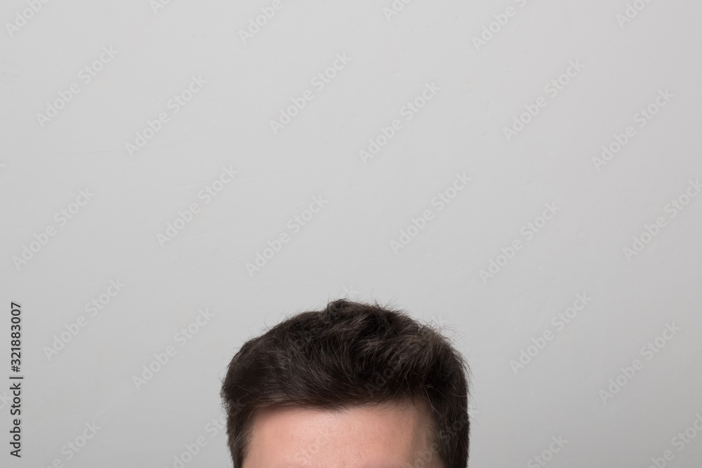 Brunette man with thick hair. Men's head. Studio image men's hairstyle. Brunette man with thick hair. Men's head. Studio image men's hairstyle.