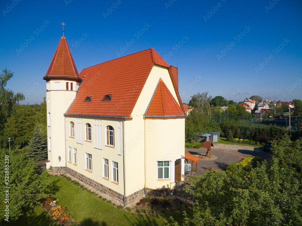 Aerial view of Wegorzewo town, Poland (former Angerburg, East Prussia). Catholic Good Shepherd Church in the foreground