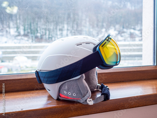 Ski or snowboard helmet and goggles. The concept of skiing and mountain winter sports.
