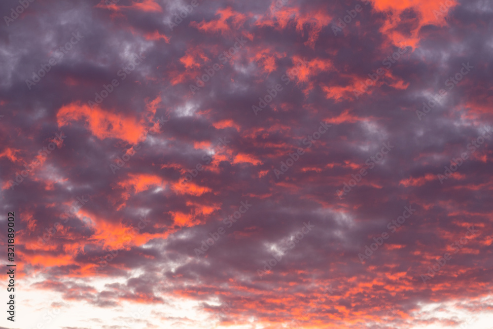 beautiful red sunrise. Bright red and blue clouds in the sky.
