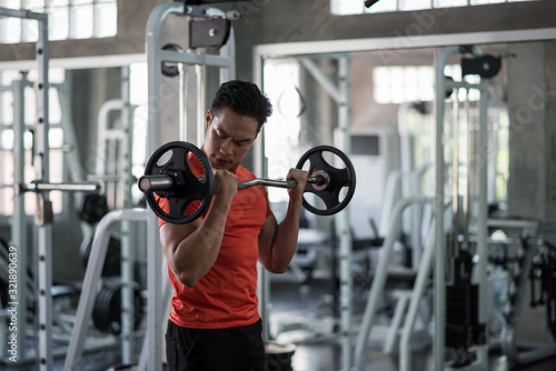 man exercise barbell weights at gym