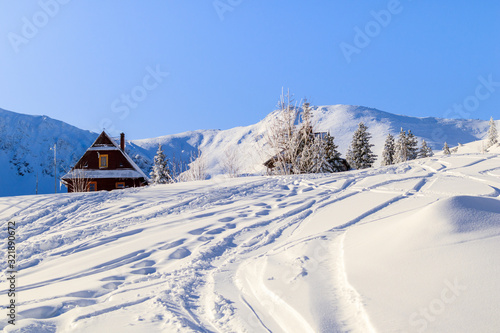 Old wooden mountain hut in beautiful winter landscape of Gasienicowa valley after fresh snowfall, Tatra Mountains, Poland