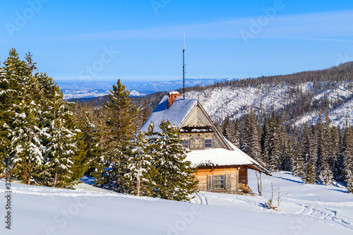 Old wooden mountain hut in beautiful winter landscape of Gasienicowa valley, Tatra Mountains, Poland