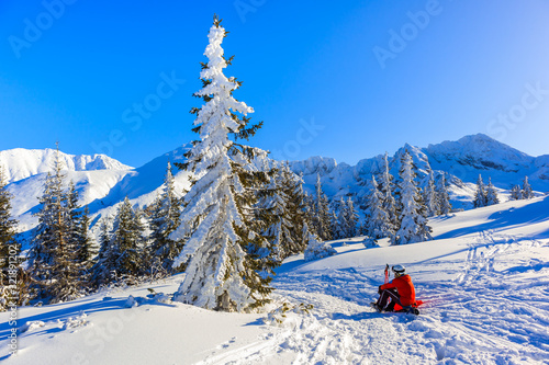 Unidentified skier backpacker on trail in Gasienicowa valley during winter time, Tatra Mountains, Poland