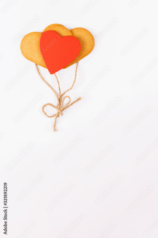 Balloons from heart shaped cookies on a white backround. Simbol of cozy love and Valentines Day backrgound, greeting card