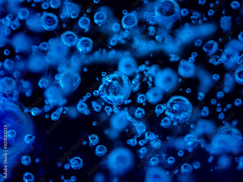 Water bubbles frozen in ice. White bubbles frozen in black ice. Hundreds of air bubbles are locked in the frozen water with no backlight. Water bubbles frozen in ice. White bubbles frozen in black ice. Hundreds of air bubbles are locked in the frozen water with no backlight.