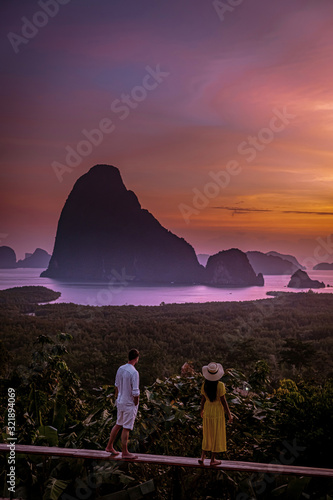Tableau sur toile couple watching sunrise over the bay of Phangnga Thailand, men and woman at Same