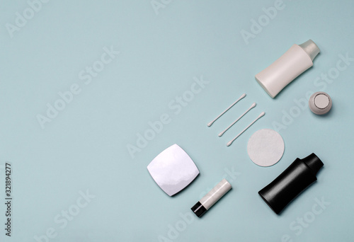 Set of cosmetic products on a blue background, flat lay with copy space. Skin, body care. Branding mock up, top view. Beauty salon treatment concept. Minimalism photo