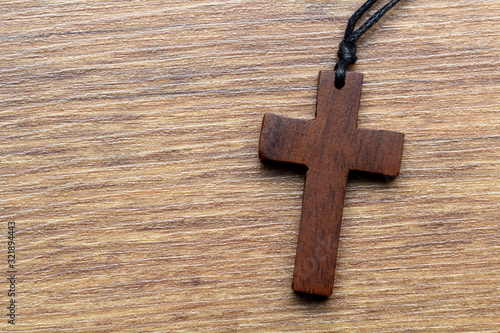 wooden cross on wooden background © OFC Pictures