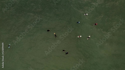 Aerial view of surfers and bodyboarders waiting for waves. Biarritz, France. photo