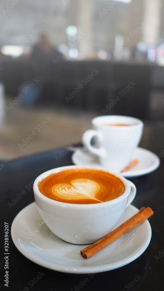 Selective focus cup of hot coffee on table in coffee shop with blurred backgrounds