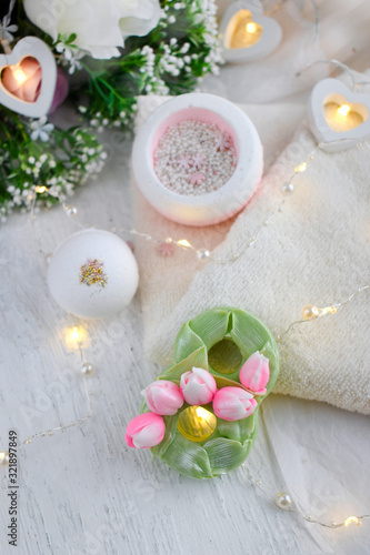 Beautiful spa composition with bath bombs, flower soap, towel on light background. Mothers day, Women day or wedding lifestyle concept. 8 March greeting card