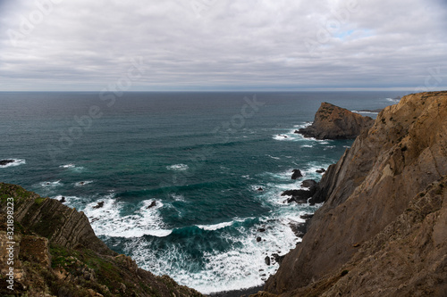 Beautiful rocky coastline and blue sea in Portugal © Alexey Seafarer