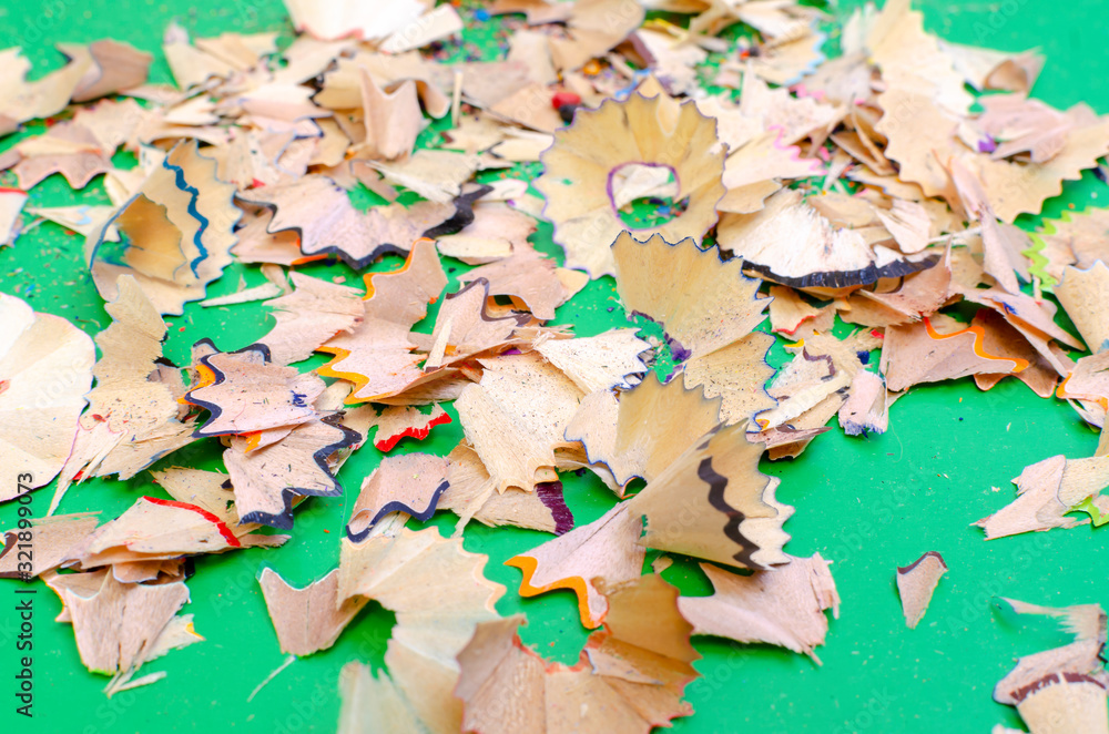 on a green background shavings from colored pencils on a green background shavings from colored pencils