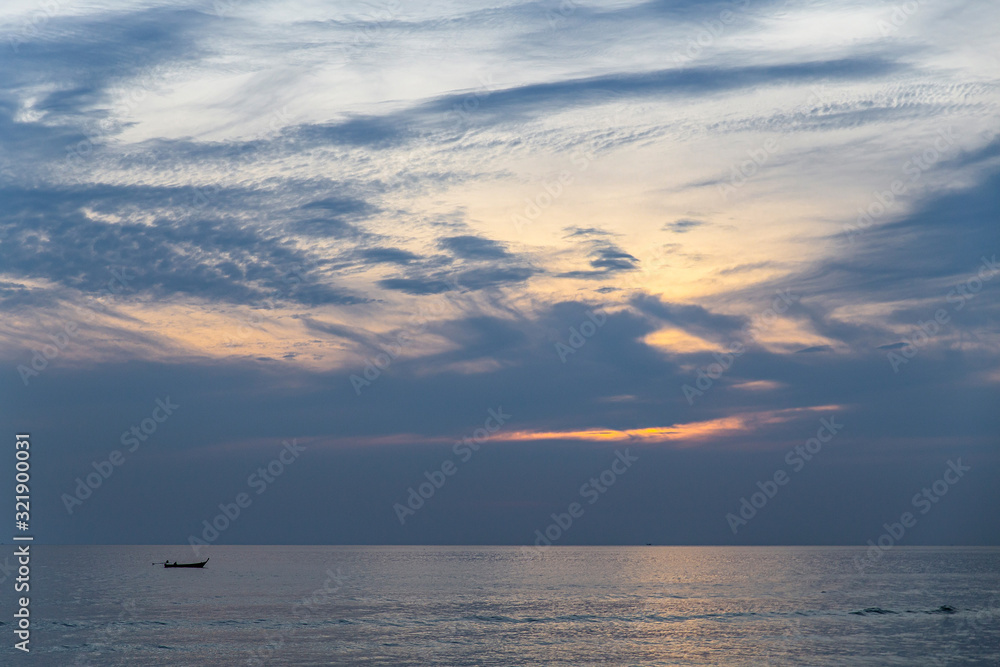 Fisherman on a boat and sunset at sea. Phuket, Patong, Thailand.