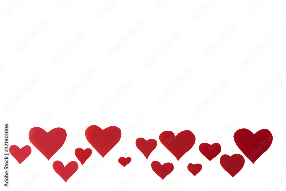 red hearts on a white background. Valentine's day concept focus on the bottom of the frame. Place for text in the middle.