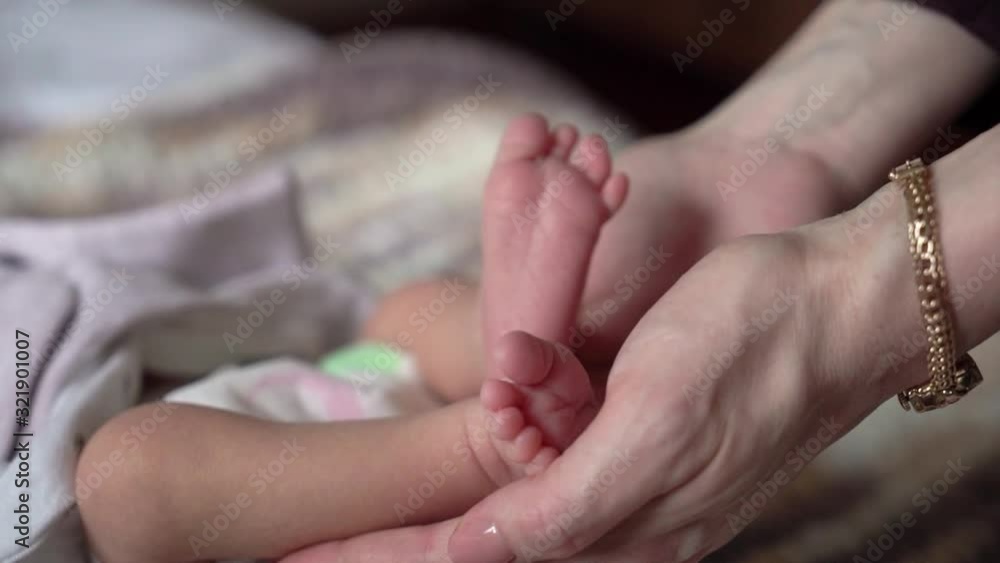 Mom holding her newborn baby legs. Mom holding her newborn baby legs.