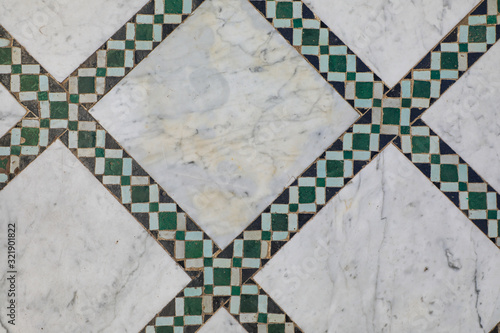 Geometric green tiles on marble floor