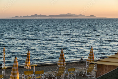 beach at sunset with orange sky in Follonica photo