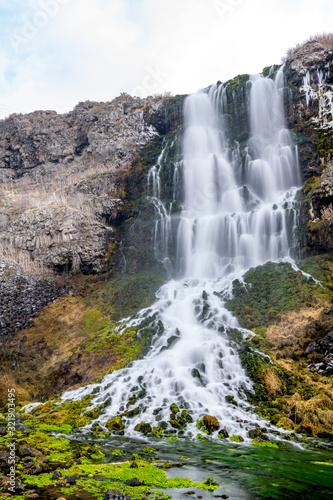 Large waterfall flows over a cliff in the Idaho wilderness