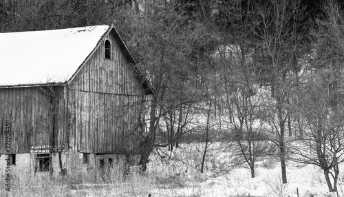 Weathered wood barn in winter