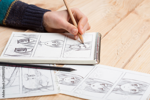 Artist drawing an anime comic book in a studio. photo