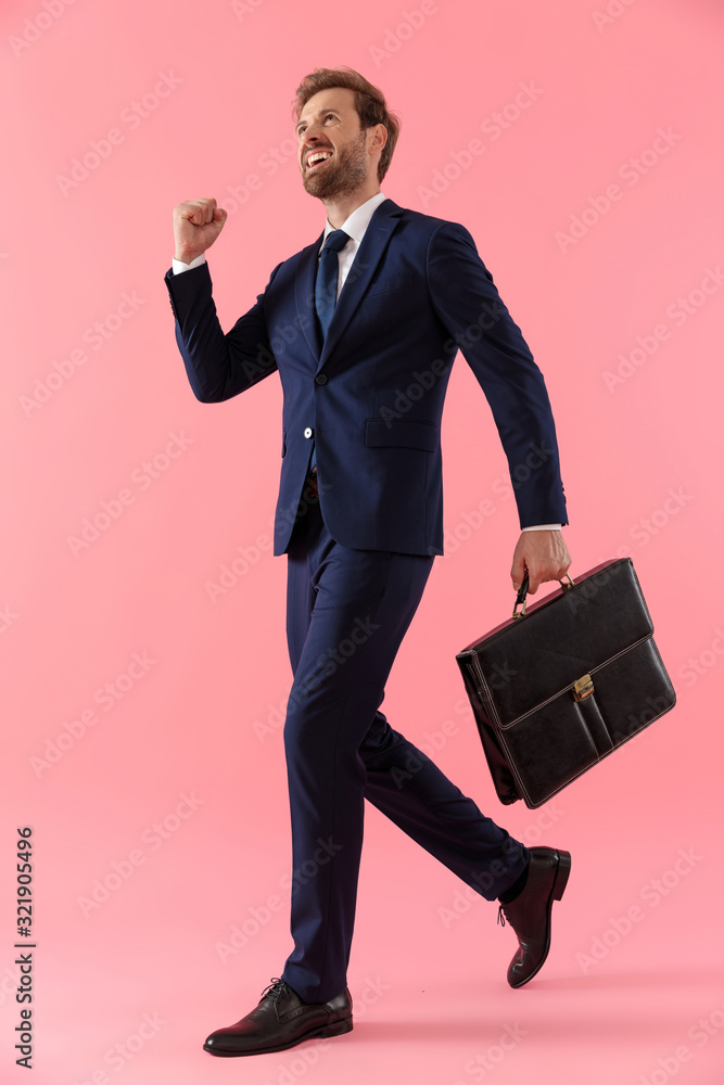 Joyful businessman holding a briefcase and celebrating, shouting Joyful businessman holding a briefcase and celebrating, shouting