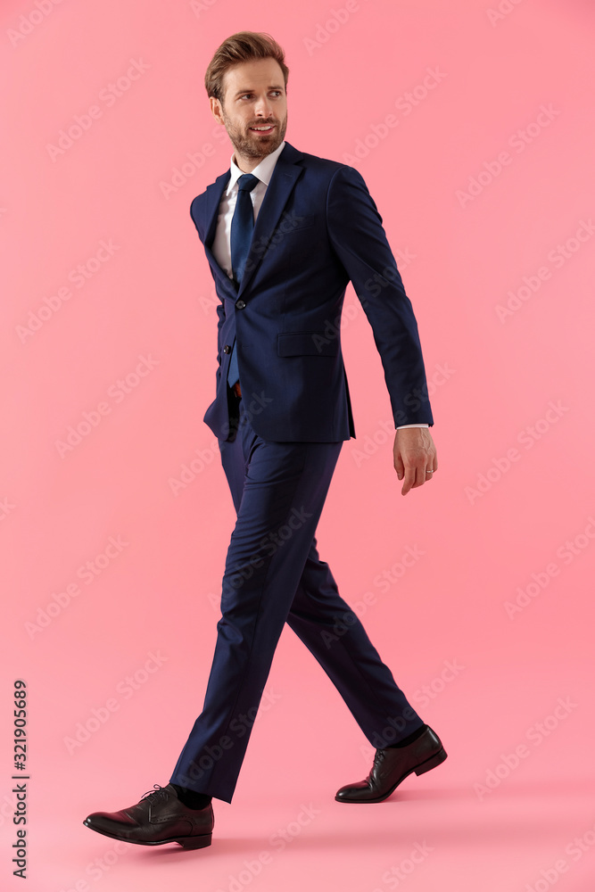 Joyful businessman holding his hand in pocket and looking away Joyful businessman holding his hand in pocket and looking away